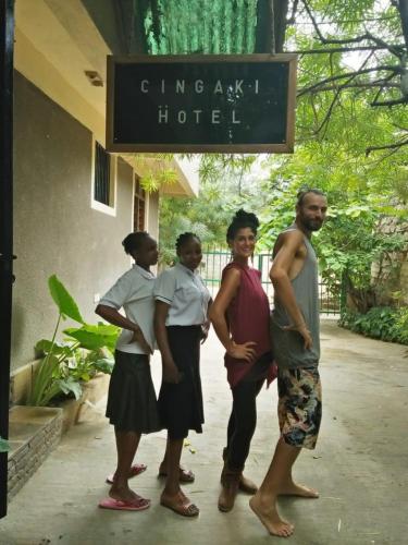 a group of people standing in front of a hotel at Cingaki Hotel in Mombasa