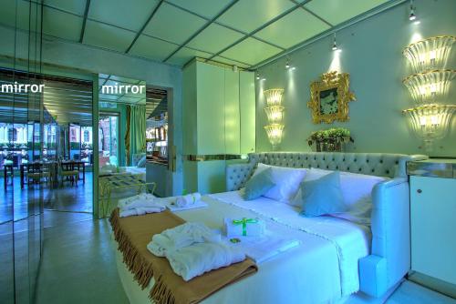 - une chambre avec un grand lit blanc et des serviettes dans l'établissement GranDELUX-Canal, à Venise