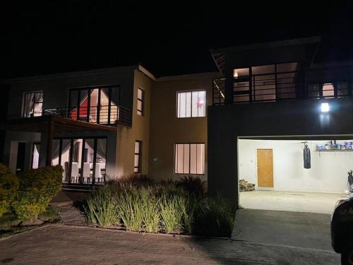 a building at night with the front of it at Sermj Abode Nkoyoyo in Mbabane