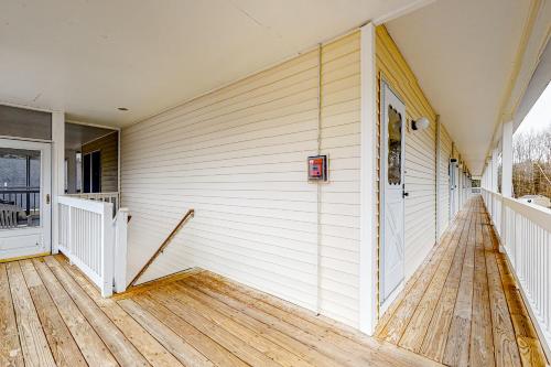 a white house with a door and a wooden floor at Wellington Manor 240 in Wells