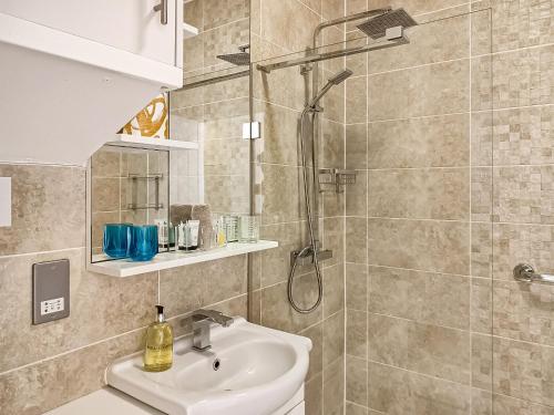 a bathroom with a sink and a shower at Springhill Court in Bewdley