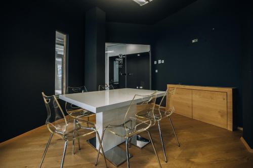 a kitchen with a table and chairs and a mirror at Postcard Country Apartments in Spodnji Duplek