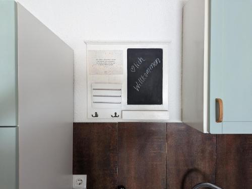 a kitchen with a sink and a chalkboard on the wall at Ferienwohnung/Monteurwohnung Altes Café in Weimar