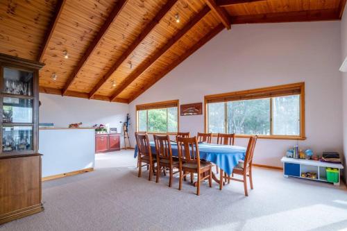a dining room with a blue table and chairs at Ashani - My house is your house. in Augusta