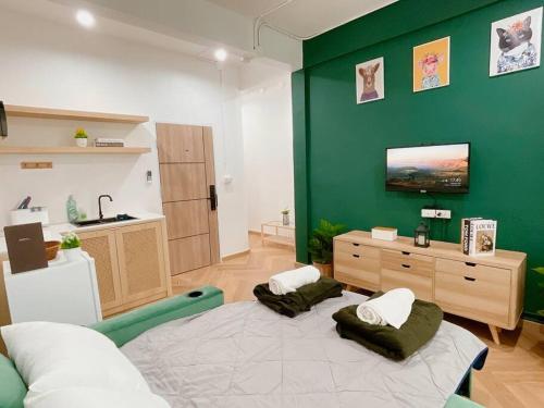 a living room with a green wall and a bed at Entire floor,Decorated cozy home, near Grand Palace in Bangkok