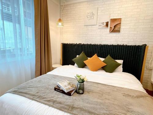 a bed with a vase of flowers on top of it at Entire floor,Decorated cozy home, near Grand Palace in Bangkok
