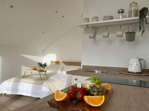 a kitchen with a table with fruits and vegetables on it at The Perch in Bridgend