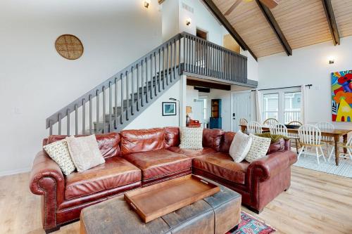 a living room with a brown leather couch at Town of Dewey Beach --- 6 Jersey Street in Dewey Beach