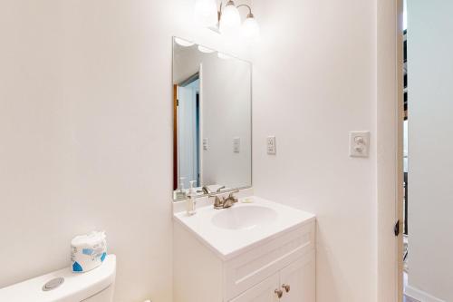a white bathroom with a sink and a mirror at Town of Dewey Beach --- 6 Jersey Street in Dewey Beach