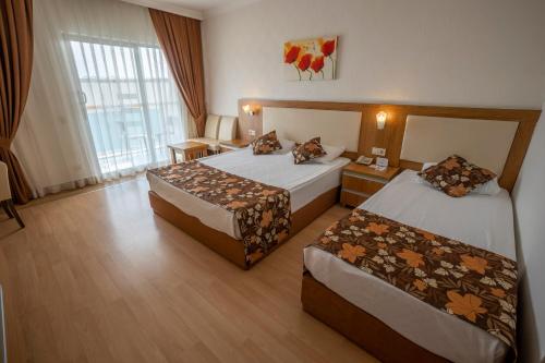 Postel nebo postele na pokoji v ubytování Cenger Beach Resort Spa - All Inclusive