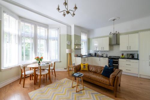a living room with a couch and a table at Prime Location Cardiff Pontcanna Modern 2 Bedroom Apartment with Privat Parking in Cardiff