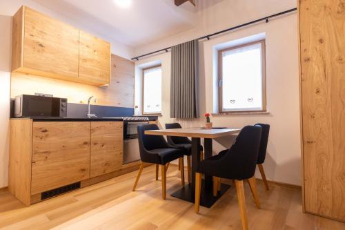 a kitchen with a table and chairs in a room at Boutique Hotel Vila Loka in Škofja Loka