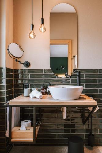 a bathroom with a sink and a mirror at Hotel Fiescherblick in Grindelwald
