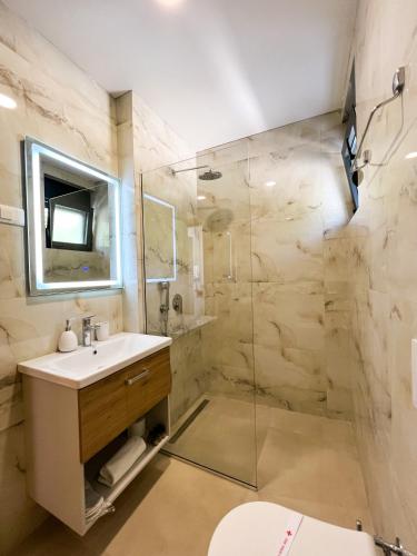uma casa de banho com um lavatório e um chuveiro em Square Residence em Ulcinj