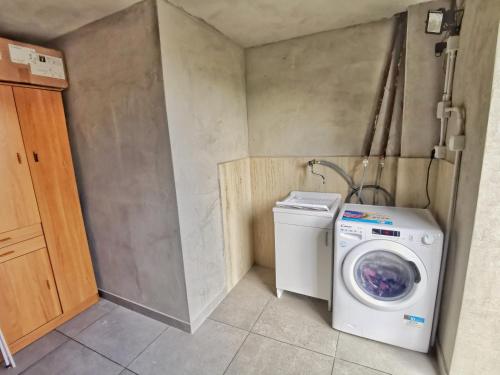 a laundry room with a washing machine and a washer at LamaDue - Casa Vacanze in Borra