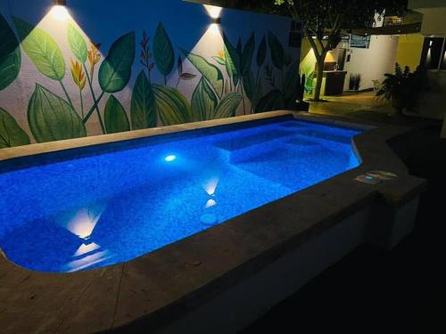 a large blue swimming pool in front of a wall at CASA MAYA in La Paz