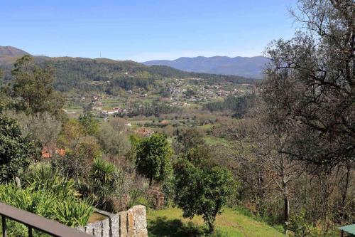 a view of a town from a hill with trees at Quinta Ecológica da Peneda Agroturismo by Peneda ecofarm in Arcos de Valdevez