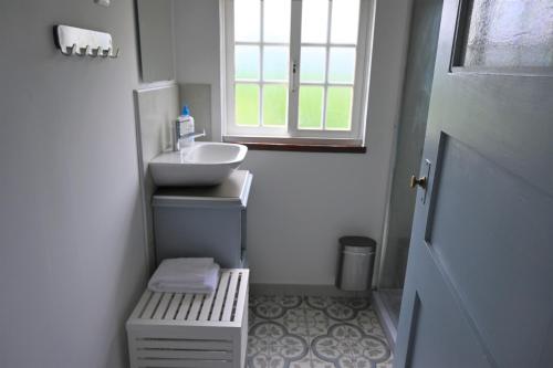 a small bathroom with a sink and a window at Quinta Ecológica da Peneda Agroturismo by Peneda ecofarm in Arcos de Valdevez