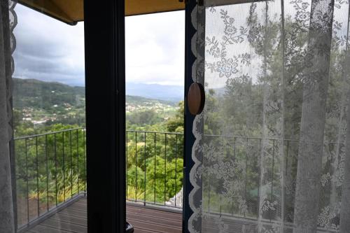 a room with a window with a view at Quinta Ecológica da Peneda Agroturismo by Peneda ecofarm in Arcos de Valdevez