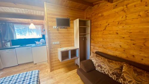 a bedroom with wooden walls and a bed in a room at Vacation Without Make Up in Šventoji