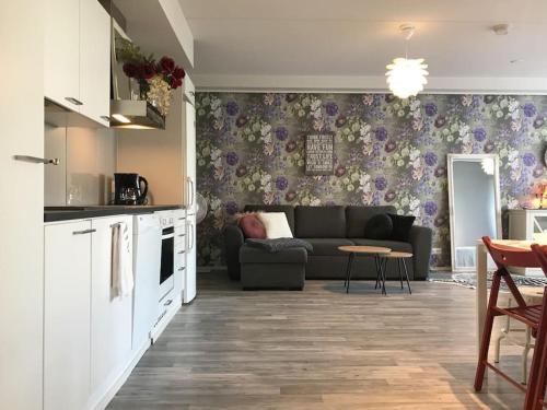 a living room with a couch and a table at Aurora Home Kivistö 1-bedroom apartment for up to 8 near Helsinki Vantaa Airport and Helsinki city center in Vantaa