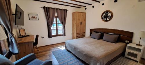 1 dormitorio con 1 cama, 1 silla y 1 ventana en Villa Viara, en Pchelnik