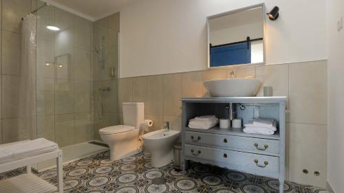 a bathroom with a sink and a toilet and a shower at Quinta Ecológica da Peneda Agroturismo by Peneda ecofarm in Arcos de Valdevez
