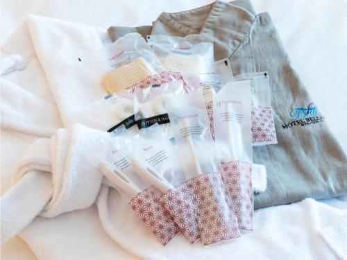 a pile of toothbrushes sitting on top of a towel at Hotel BELLMARE ホテルベルマーレ in Maizuru