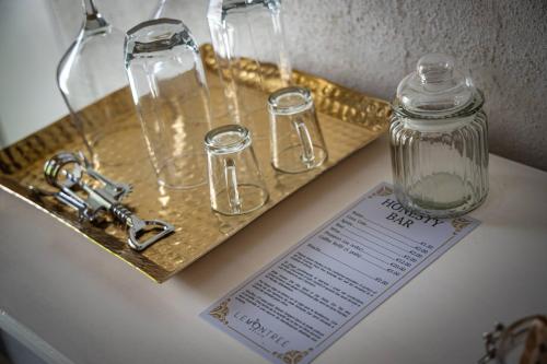 a tray with glasses and a glass jar on a counter at Lemon Tree Relais by CX Collection in Żabbar