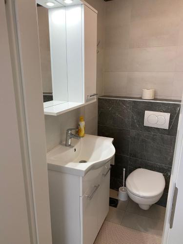 a bathroom with a white sink and a toilet at Rooms Jelena in Dubrovnik