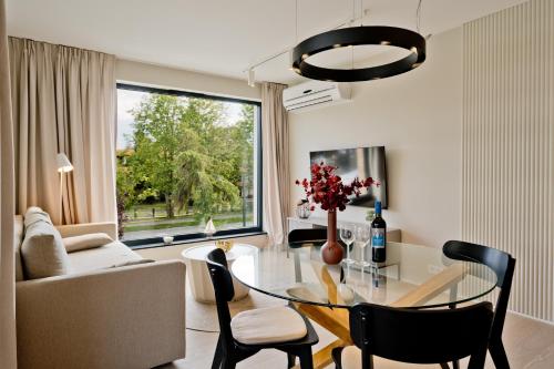 a living room with a glass table and a couch at Apartamenty Wydma & Las BlueApart in Jastarnia