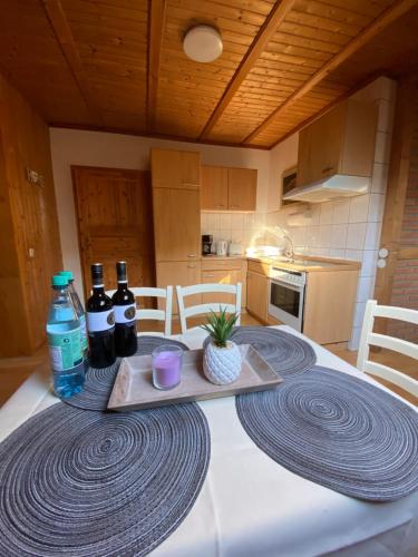 a kitchen with a table with a tray of wine bottles at Attraktiver Luftkurort Winterberg in Winterberg