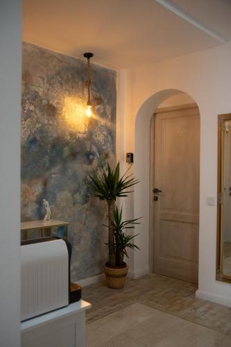 a hallway with a potted plant in front of a door at CASA CIUC in Sibiu