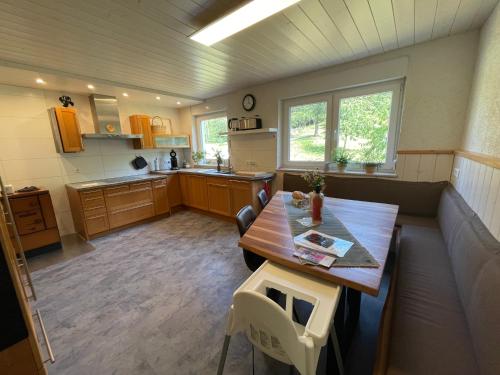 a large kitchen with a wooden table and chairs at s`Lähmes auf der Schwend in Kappelrodeck