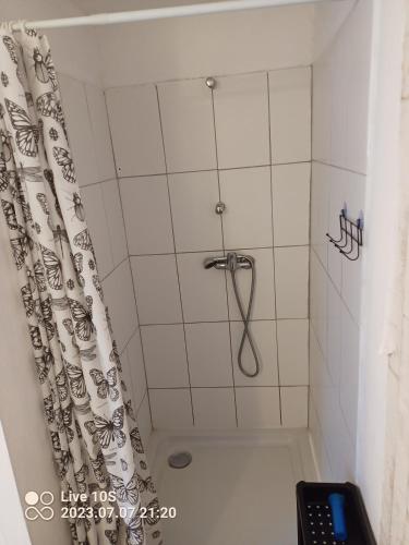 a bathroom with a shower with a shower curtain at Zielony Port numer 3 in Władysławowo