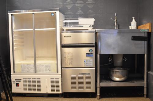 a kitchen with an open refrigerator and a mixer at TORUS 修善寺 Condominium 貸切宿 in Izu