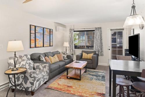 a living room with a couch and a table at First Tracks 3301 Condo in Steamboat Springs