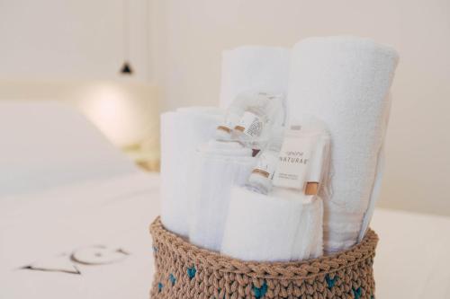 a vase filled with towels and toilet paper at Villa Giulietta Hotel in Castiglioncello