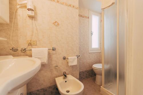 a bathroom with a sink and a toilet at Villa Giulietta Hotel in Castiglioncello