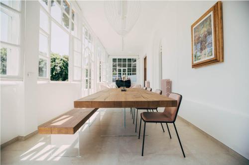 a dining room with a wooden table and chairs at Villa Giulietta Hotel in Castiglioncello