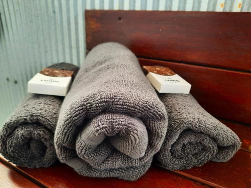 two towels sitting on top of a wooden table at Wild Nature Lodge, Mareeba Wetlands in Biboohra
