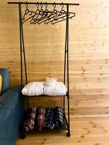 a iron shelf with hats on it in a room at Qusha Cottage in Kazbegi