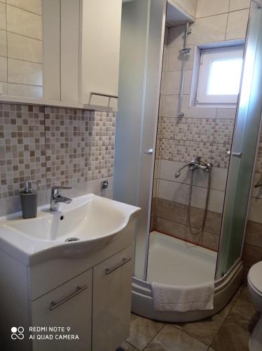a bathroom with a sink and a shower at Apartments Panorama in Korčula