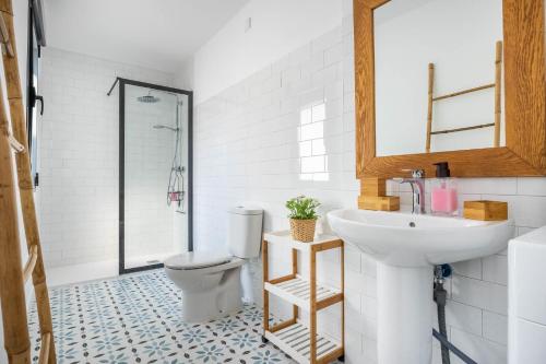 a bathroom with a toilet and a sink at Slow Sevilla suite - two-bedroom apartment with private pool in Seville