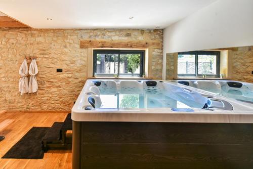 a large bathroom with a large bath tub at lov'HOME in Caussade