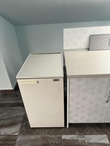 a white refrigerator and a counter in a room at MESAGGALA PALACE No 3 FIRSTLINE SEA in Néa Meságkala