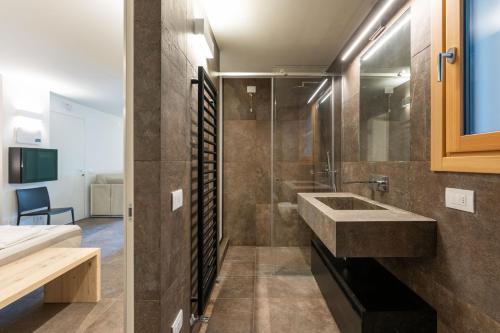 a bathroom with a sink and a shower at Agriturismo Scraleca in Angolo Terme