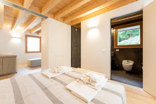 a bedroom with two beds and a bathroom at Agriturismo Scraleca in Angolo Terme