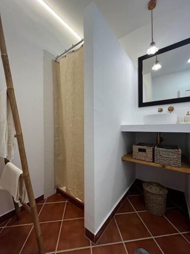 a bathroom with a sink and a mirror at Suite en el corazón de Doñana in El Rocío