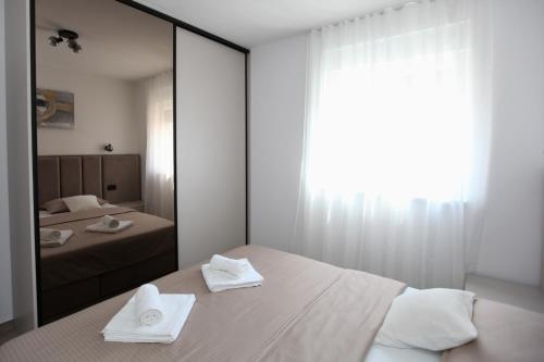 a bedroom with two beds and a large mirror at Apartment Sweet Dreams in Trogir